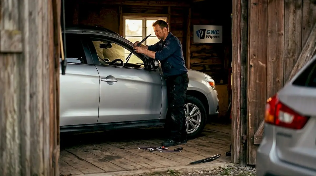 Mechanic installing windscreen wiper on Mitsubishi ASX