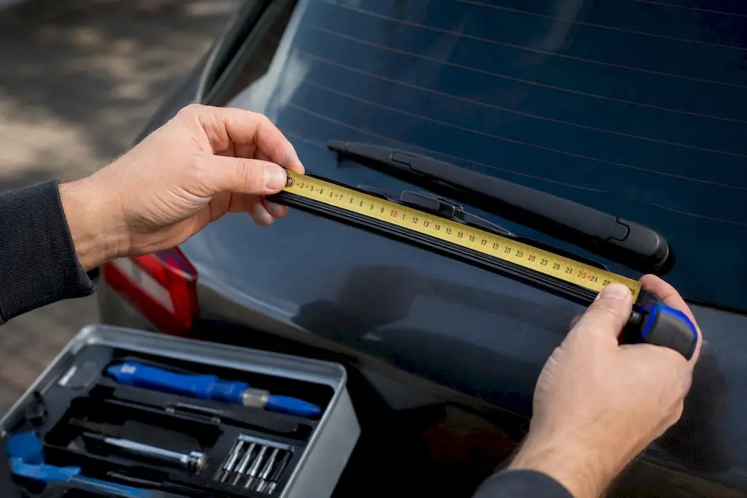 Hands measuring rear wiper blade size
