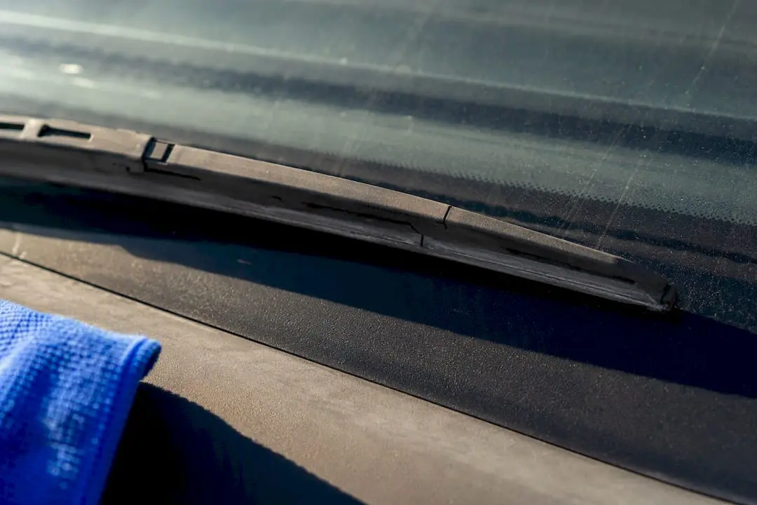 Sun damaged wiper blade on dry windscreen