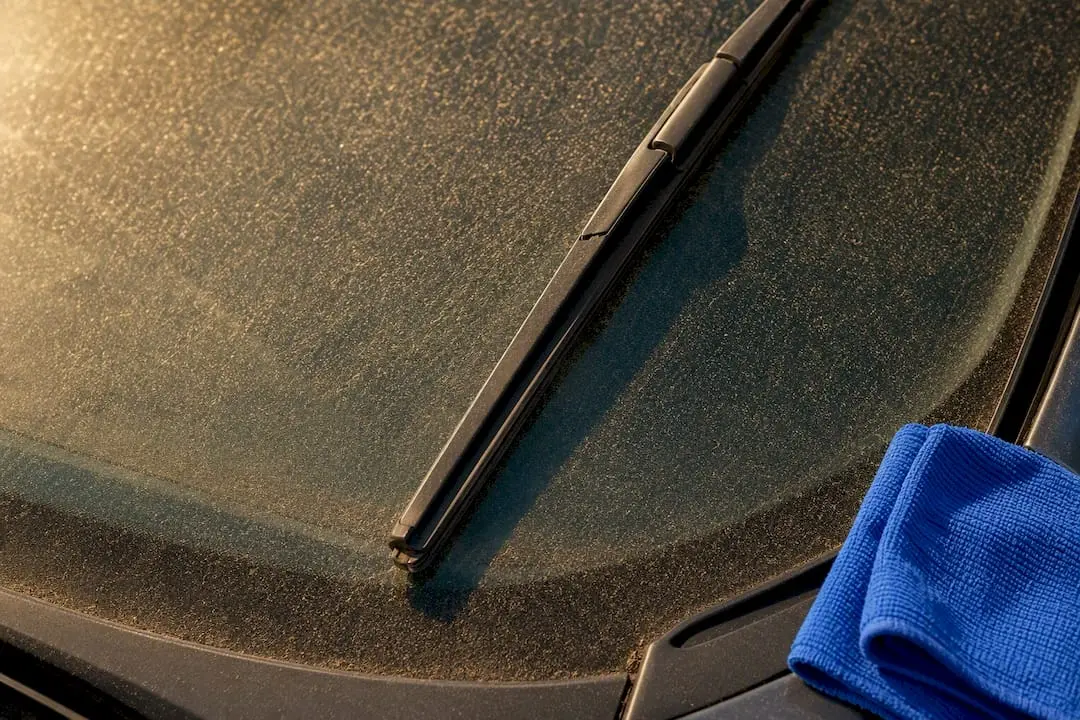 Dusty windscreen beside stiffened wiper rubber