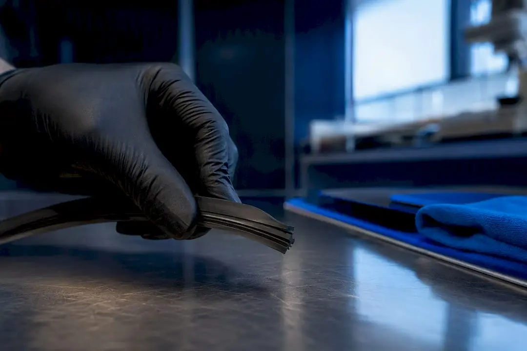 Technician inspecting natural rubber blade edge