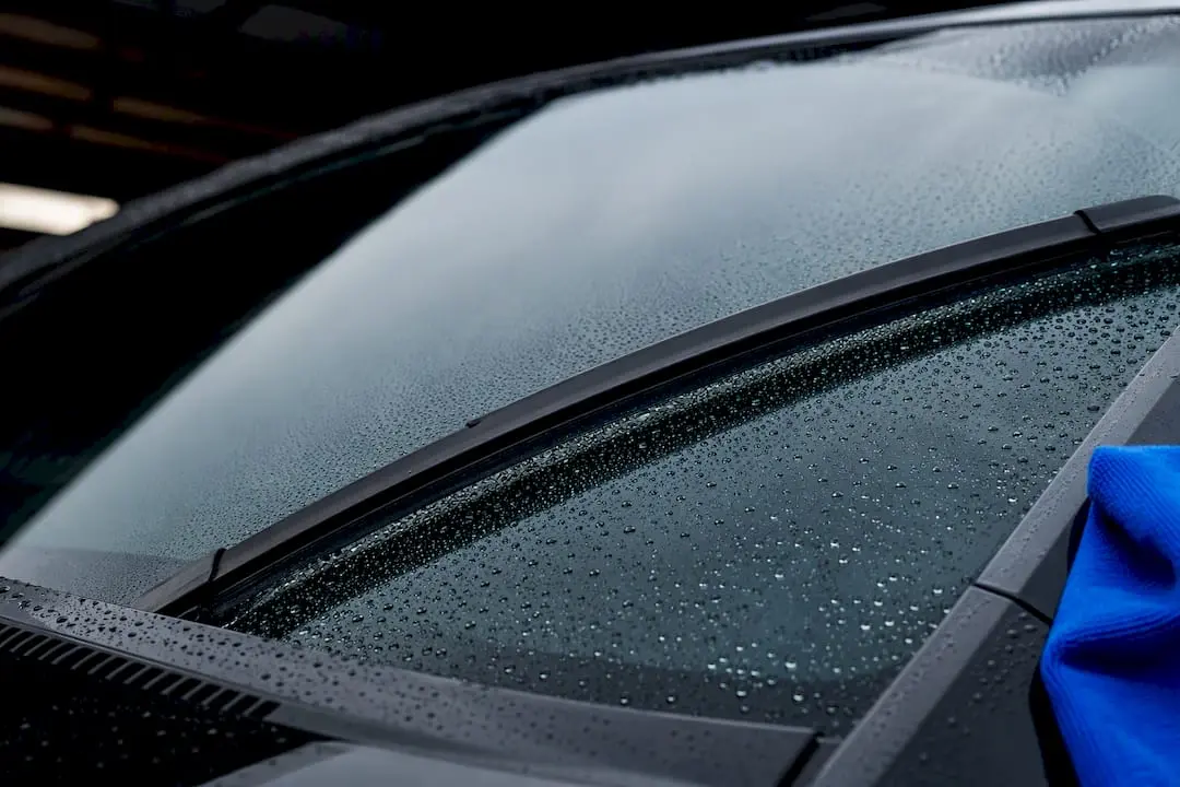 Wiper moving across beaded coated windscreen