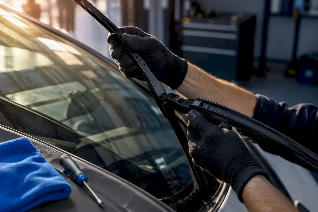 Wiper blade positioned on raised arm